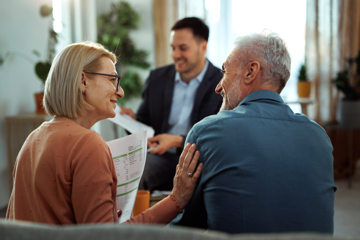 Mature couple having meeting with financial advisor at their aparemtnt